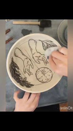 a person is drawing on a white plate