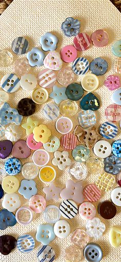 many different colored buttons on a table