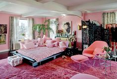 a bedroom decorated in pink and black