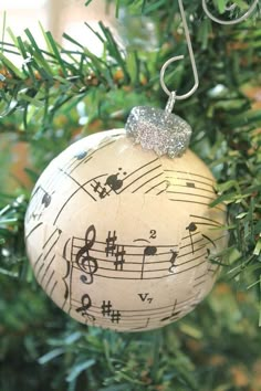 an ornament hanging from a christmas tree with musical notes on it's ball