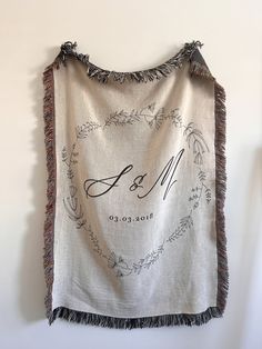 a white wall hanging with a couple's initials on it