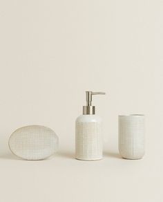 a white bathroom set with soap dispenser and sponge