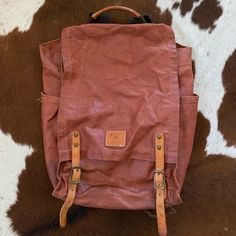 Awesome Camping/Beach/Traveling Backpack. This Bag Is Awesome Because It Can Either Be Buckled Or Unsnapped For Quick Access To Your Things. In A Lovely Rosey Wine Burgundy Color. It Fits A Lot Of Stuff And The Woven Straps Are Very Comfortable And Soft. Rectangular Leather Backpack With Waxed Finish For Everyday, Everyday Use Leather Backpack With Waxed Finish, Everyday Rectangular Leather Backpack With Waxed Finish, Coated Canvas Leather Backpack For Travel, Leather Trim Satchel Backpack For Daily Use, Vintage Leather Backpack With Leather Handles For Everyday, Waxed Leather Satchel Backpack, Casual Backpack With Leather Lining, Everyday Bags With Leather Backing And Coated Canvas