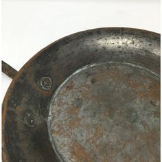 an old frying pan sitting on top of a table