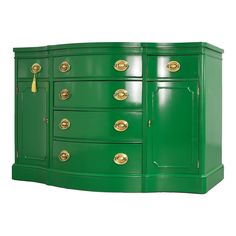 a large green dresser with gold handles and knobs on it's doors, against a white background