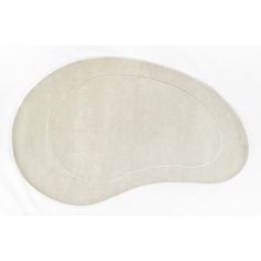 an oval white rug on a white background