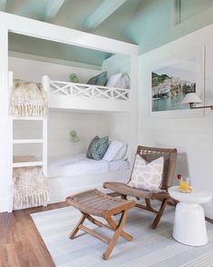 a room with bunk beds and chairs in it