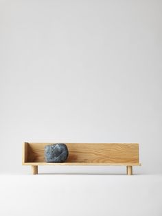 a rock sitting on top of a wooden shelf