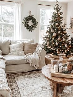 a living room with a christmas tree in the corner and other decorations on the table