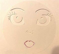 a paper cut out of a woman's face with eyes and eyelashes on it