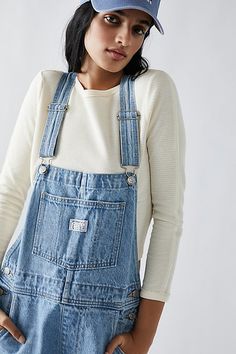 The perfect vintage-inspired overalls from Levi's, this distressed style is featured in a classic bib-and-brace silhouette with front pouch pocket and relaxed, straight leg design. * Adjustable straps * Four pocket design * Side button closures * Logo patch detail at front | Levi's Vintage Overalls at Free People in Light Wash, Size: XS White Overalls, Vintage Overalls, Levis Vintage, Blue Jumpsuits, Levis Women, Jumpsuit Fashion, Dungarees, Vintage Levis, Pocket Design