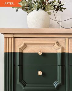 a vase with flowers on top of a green dresser next to a white potted plant