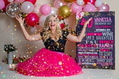 a woman in a pink and black dress with balloons