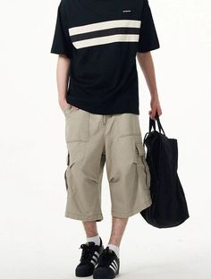 Embrace practicality with a touch of streetwise style in our Cargo Pocket Knee-Length Capri Shorts, designed for the modern man. Crafted with utmost attention to detail, these knee-length shorts feature a robust fabric blend that's pre-washed for a lived-in feel. The multiple cargo pockets not only enhance the utilitarian appeal but also add a layer of functionality, perfect for keeping your essentials at hand. The straight, loose fit ensures ease of movement and comfort throughout your day. Whe Casual Relaxed Fit Cargo Pants With Built-in Shorts, Summer Knee-length Cargo Pants With Built-in Shorts, Baggy Knee-length Pants With Pockets, Casual Khaki Bermuda Bottoms, Casual Baggy Knee-length Pants, Casual Knee-length Pants With Pockets, Summer Knee-length Bottoms With Cargo Pockets, Casual Cargo Style Shorts For Streetwear, Casual Streetwear Shorts With Multiple Pockets