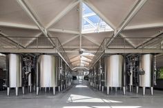 the inside of a building with several large tanks in it's center and skylights overhead