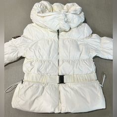 Stay Warm And Stylish This Winter Season With This Triple F.A.T. Goose Down Puffer Jacket. The Jacket Features A Full Zip Hood And Is Made With High-Quality Polyester Material For Durability And Protection. The Insulation Material Is Made Of Down, Providing Extra Warmth And Comfort. This White Puffer Jacket Is Designed For Women In Size L And Is Perfect For Any Casual Occasion. The Jacket Also Comes With A Range Of Features Such As A Hood And A Full Zip That Makes It Easy To Wear And Take Off. G White Parka With Double-lined Hood For Cold Weather, White Parka With Adjustable Hood For Cold Weather, White Hooded Parka For Cold Weather, White Hooded Parka With Double-lined Hood, White Nylon Hooded Jacket For Fall, White Outerwear With Detachable Hood For Outdoors, Hooded Winter White Outerwear For Cold Weather, White Nylon Puffer Jacket With Double-lined Hood, White Puffer Jacket With Detachable Hood For Fall