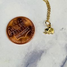 "A beautiful 14K solid yellow gold tiny etched lucky elephant pendant charm. It has a soldered ring to attach to a bracelet or a necklace. The very delicate pendant measures 6.1mm tall with bail and without the soldered ring and 6.9mm wide. It can be used as a necklace pendant or a bracelet charm and would make a perfect gift. The pendant can be paired with a shiny 14K Yellow Gold 1.2mm cable link chain in either 16\" or 18\" length or with a 16\" 14K gold-plated cable link chain. All items come Dainty 14k Gold Filled Engraved Charm Necklaces, Dainty Yellow Gold Brass Charm Necklace, Dainty Gold Plated Nickel-free Charm Necklaces, Dainty Yellow Gold Dangle Charm Necklaces, Dainty 14k Gold Adjustable Charm Necklace, Dainty Charms Suitable For Gifts, Dainty Recycled Gold Jewelry With Charms, Dainty Tiny Charms For Gifts, Tiny Dainty Charms As Gifts