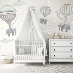 a baby's room with an elephant and hot air balloons