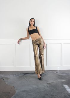 Vintage 90s bronze soft leather mid/high rise pants. Fully lined. Cool buckle detail on waist. condition: excellent label: no tags  era: 90's fabric: leather size: marked US 2 waist: 30" hips: 36" rise: 10"- 12.5" inseam: 34" length: 42" | model measures 32"-26"-36" | 5'9" | ♡ We only sell vintage items. Vintage items may come with minor flaws. We will do our best to clean|mend every garment as needed. ♡ We love vintage and support sustainability. All items are sold as is.  ♡ Returns are not acc Metallic Straight Leg Leather Pants For Night Out, Chic Metallic Straight Leg Leather Pants, Chic Fitted Metallic Leather Pants, Fitted Gold Wide Leg Pants, Fitted Straight Leg Gold Pants, Gold Fitted Straight Leg Pants, Kick Flare Pants, Kick Flares, Love Vintage