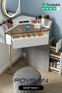 a white vanity with drawers and a mirror on the wall next to a stool in front of it