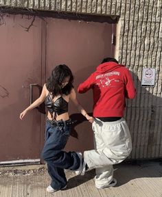 a man and woman dancing in front of a door