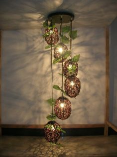 a bunch of lights that are on some kind of plant hanging from a light fixture