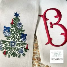 two embroidered christmas stockings with the letter b in red, white and blue on them