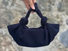 "🔘 This Elegant Satin Knot bag is ideal for the wedding day, night out, party, special occasion, brides, bridesmaids, mothers of the bride, or any formal fun. 🔘 This bag has a snap closure and is inside a felt pouch. The Video shows the handbag in a small size. You can put an iPhone Plus into the bag and also some other essentials in it. is perfect for a night-out bag - comfortably fits my iPhone 14 Plus, lipstick, and a coin purse.   🔘 Dimensions of the inside zippered pouch: L17 cm x H10 cm Japanese Knot Bag, Knot Bag, Night Out Party, Felt Pouch, Bridesmaid Clutches, Potli Bags, Party Purse, Bridal Clutch, Elegant Bags