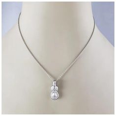 This sparkling pendant necklace features one pear shaped diamond, one emerald cut diamond and 11 round brilliant cut diamonds set in classic 18K white gold.  Total diamond weight: 1.18 ct.  Diamond color:  G-H  Diamond clarity:  VS1-VS2  Stamped: 750  Size:  16.75 inches (necklace)  22 mm x 9 mm (pendant)  Weight: 5.8 gr./ 3.7 dwt.  JAGi Certificate included  Very good condition, professionally polished.  Will come packaged in a gift box or pouch (when possible) and will be shipped U.S. Priority Mail Insured. White Cubic Zirconia Teardrop Pendant Diamond Necklace, White Cubic Zirconia Teardrop Pendant Necklace, White Teardrop Cubic Zirconia Diamond Necklace, White Gold Cubic Zirconia Pear-shaped Drop Necklace, Pear-shaped White Gold Drop Necklace With Cubic Zirconia, Pink Pendant Necklace, Purple Pendant Necklace, Art Deco Pendant Necklace, Black Pendant Necklace