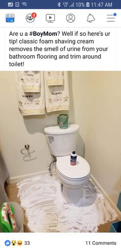 a bathroom with toilet paper on the floor and towels hanging above it that have been torn off