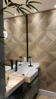 a bathroom with two sinks and a plant in front of the sink area is shown