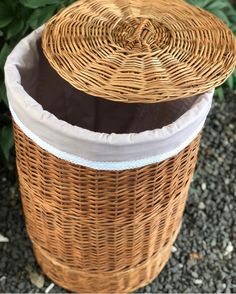 an empty wicker basket sitting on the ground