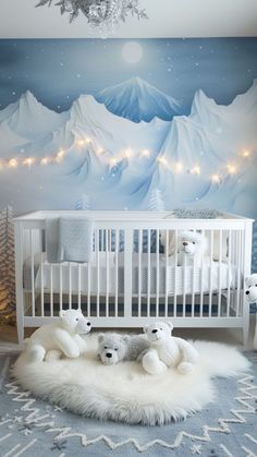 a baby's room decorated in blue and white with mountains, stars and lights