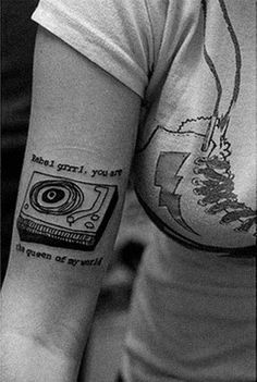 a woman with a camera tattoo on her arm