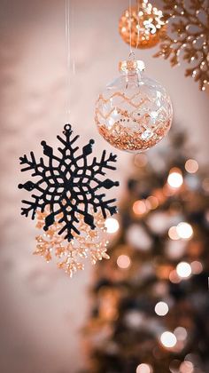 a snowflake ornament hanging from the ceiling next to a christmas tree