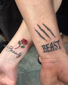 two people holding hands with tattoos on their arms and the words beast, beauty and roses