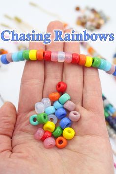 there is a hand that has some beads in it and the words chasing rainbows on it