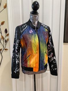 "graffiti jacket,vintage jacket,faux leather,painted jacket,upcycled jacket,love,peace,hand painted coat,splatter jacket Unique One of a kind custom made upcycled painted jacket Be the first to own one of our custom, made to order Fashionable jackets So comfy! Make a Unique fashion statement when wearing. You're guaranteed to attract attention with this unique one of a kind item. Jazz up an everyday outfit, bring some life to the boring outfit and wear as a cover up, wear as a fashion statement Casual Fitted Outerwear With Graffiti Print, Artistic Winter Streetwear Outerwear, Artistic Winter Outerwear For Streetwear, Edgy Multicolor Outerwear For Fall, Fitted Graffiti Print Outerwear For Fall, Edgy Long Sleeve Outerwear With Graffiti Print, Trendy Spring Outerwear With Graffiti Print, Artistic Black Outerwear For Fall, Edgy Multicolor Spring Outerwear