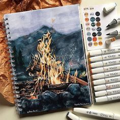 a drawing of a campfire with crayons next to it