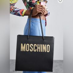 This Authentic Moschino Logo Print In Soft Black Calf Leather Is In Excellent Condition/ Brand New. It Comes With Two Rounded Top Handle , Main Compartment, Internal Zip Pocket . This Leather Tote Bag Constructed From Calf Leather, This Logo Print Tote Bag Comes With A Bold Printed Logo That Is Unmistakable. Make Your Friends Just A Little Bit Jealous. Made In Italy Product Measurements Depth 4.72 In Handle 4.33 In Height 7.87 I Am Moving And Need To Downsize My Closet. All The Bags I Listed Are Moschino Bags, Moschino Logo, Soft Black, Printed Leather, Printed Tote Bags, Leather Tote Bag, Leather Tote, Moschino, Calf Leather