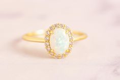 This exquisite ring is set with high-end opal, emitting a unique white light blue glow. Its minimalist design showcases elegance and nobility. It is not only a commemoration of her birthday in October, but also an expression of eternal love for her. As a special gift, whether given to her or her mother, it can convey deep warmth and blessings. ♥ Product Details ★ Material: Made of high-quality 925 sterling silver, thick plated with 14k gold ★ Inlay: High grade opal, ★ Main stone size: 6 * 8 mill Opal Rings With Halo Setting As A Gift, White Opal Ring For A Gift, White Opal Ring As A Gift, White Opal Crystal Ring For Gift, Opal Halo Ring For Gift, Opal Halo Ring As Gift, Opal Halo Rings For Gifts, Opal Halo Rings As Gifts, White Opal Ring With Halo Design For Formal Occasions