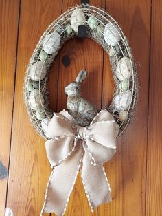 a wreath with a bunny sitting on top of it