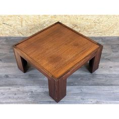 a square wooden table with two legs