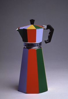 a multicolored coffee pot sitting on top of a table