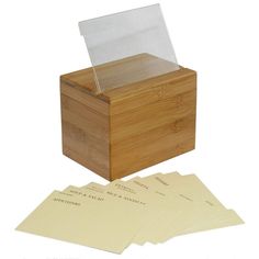 a wooden box with four sheets of paper in it