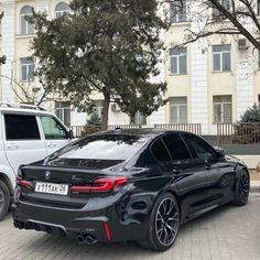 two cars parked next to each other in front of a building