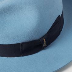 Stylish 4 1/2" center dent crown for a classic look. Sleek 3" raw edge brim adds contemporary flair. Enhanced with a premium roan leather sweatband, adorned with a 1/2" ribbon, and finished with a satin lining for ultimate comfort and luxury. "Introducing the El Capo: Your Signature European-Inspired Fedora in Powder Blue! Elevate your style with the El Capo wide-brimmed fedora, meticulously crafted to exude elegance and sophistication. Inspired by European design, this hat is the ultimate acces Blue Fedora Hat, Mens Dress Hats, Mens Hats Fashion, Wide Brim Fedora, Felt Fedora, European Design, Mens Bow Ties, European Designs, Dress Hats