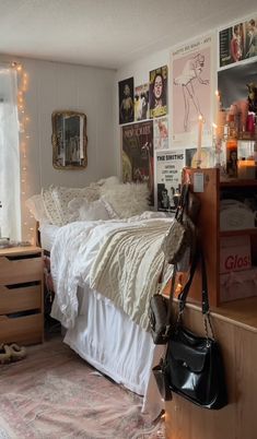 a bed room with a neatly made bed and lots of clutter on the walls