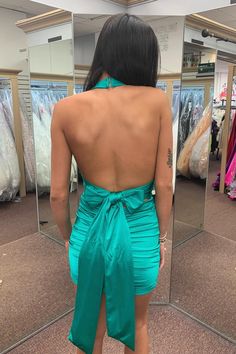 the back of a woman's dress in front of a mirror at a clothing store