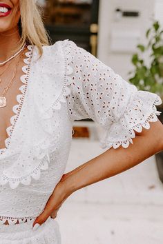 - Get a romantic look with this sweet top! - Lightweight eyelet material with a lined bodice - A scalloped v-cut neckline - A scalloped yoke - Half-sleeves with elastic ruffled cuffs and scalloped detail - A lace up back - A figure flattering silhouette that ends in an uneven scalloped hemline with back tie closure White Eyelet Top, Romantic Story, Sweet Top, Romantic Stories, Eyelet Top, Romantic Look, V Cut, White Eyelet, Comfy Hoodies